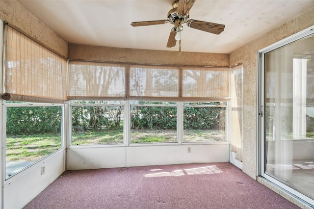 unfurnished sunroom with ceiling fan