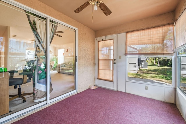 unfurnished sunroom with ceiling fan and a healthy amount of sunlight