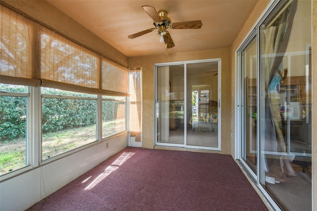 unfurnished sunroom featuring a ceiling fan