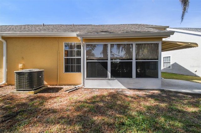 rear view of property with a patio, a sunroom, and cooling unit