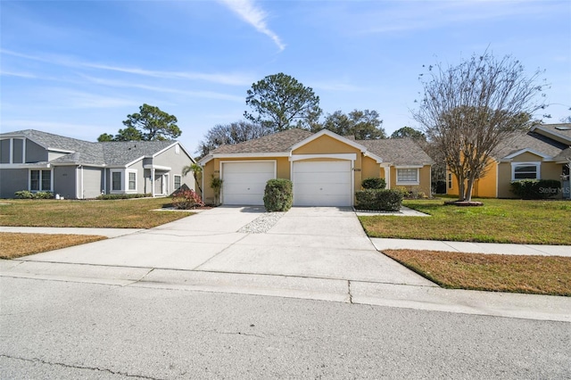 single story home featuring a garage and a front lawn