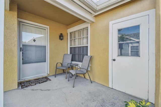 property entrance with stucco siding