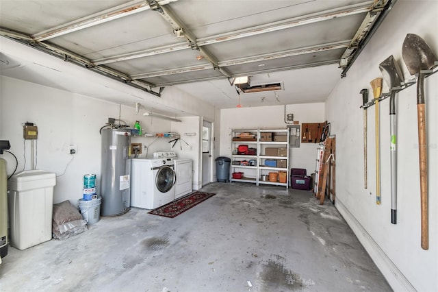 garage featuring water heater and washing machine and dryer