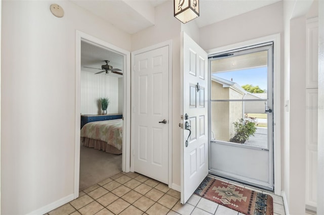 foyer entrance featuring baseboards and light tile patterned flooring