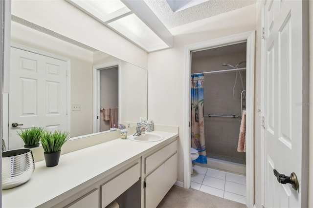 full bath featuring vanity, tile patterned floors, toilet, and a tile shower