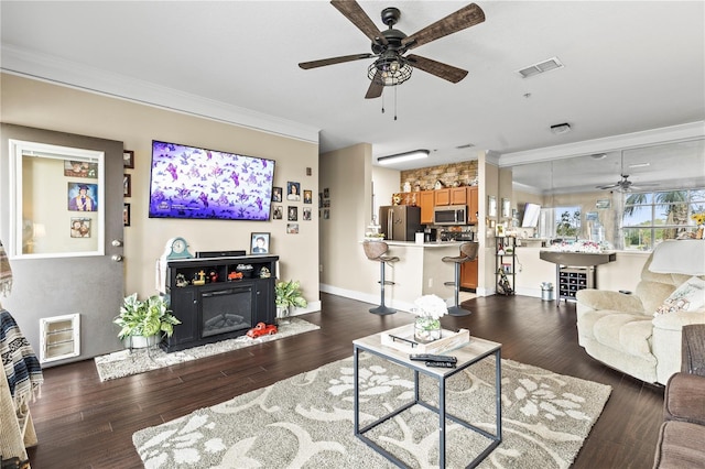 living room featuring crown molding, ceiling fan, and dark hardwood / wood-style flooring