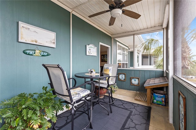 sunroom / solarium featuring plenty of natural light and ceiling fan