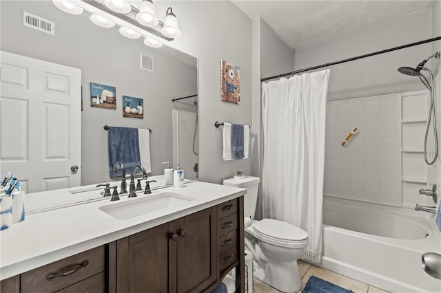 bathroom featuring visible vents, vanity, toilet, and tile patterned floors