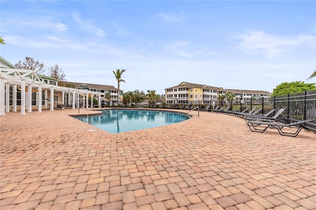 community pool with fence, a pergola, and a patio