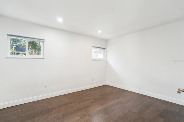 empty room with dark hardwood / wood-style flooring