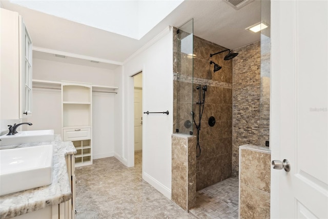 bathroom with vanity and a tile shower