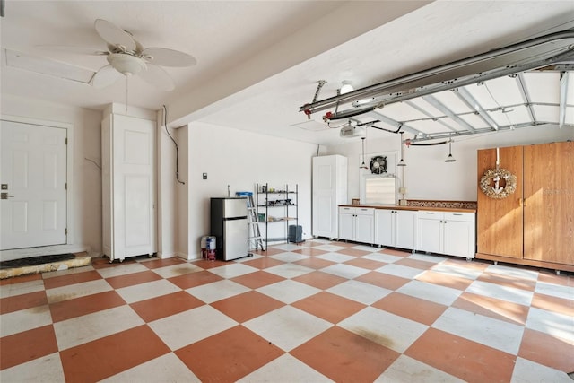 garage with a garage door opener, ceiling fan, and refrigerator