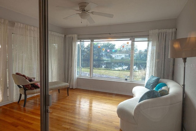 sitting room featuring light hardwood / wood-style flooring and ceiling fan