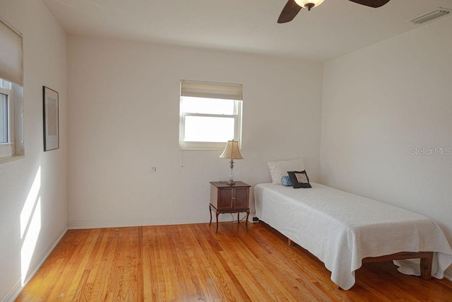 bedroom with ceiling fan and light wood-type flooring