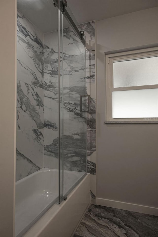 bathroom featuring combined bath / shower with glass door