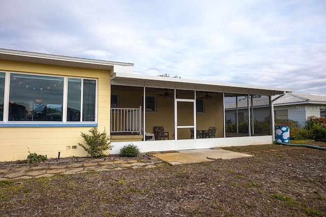 rear view of house featuring a sunroom and ceiling fan