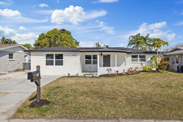 ranch-style home with central AC and a front lawn