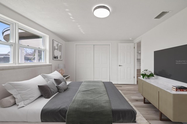 bedroom with a closet and light wood-type flooring