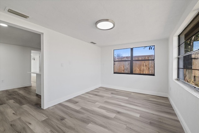 unfurnished room with light hardwood / wood-style floors