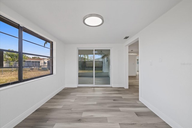 unfurnished room featuring light hardwood / wood-style floors