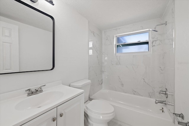 full bathroom featuring vanity, toilet, tiled shower / bath combo, and a textured ceiling