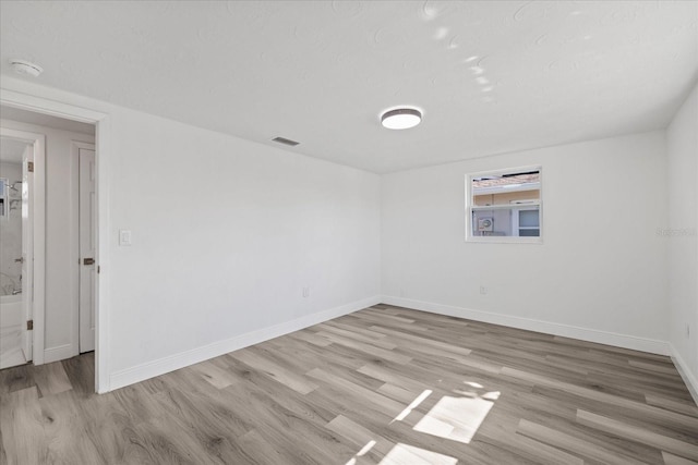 unfurnished room with light hardwood / wood-style flooring