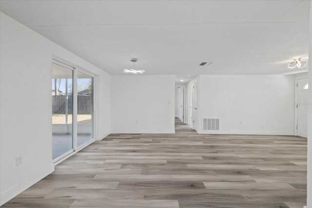 unfurnished room with light wood-type flooring