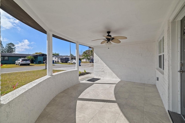 view of patio featuring ceiling fan and a porch