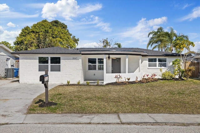 single story home with central AC unit and a front lawn