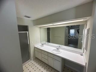 bathroom with vanity and an enclosed shower