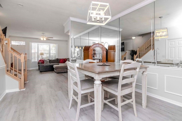 dining area featuring crown molding, ceiling fan, and light wood-type flooring