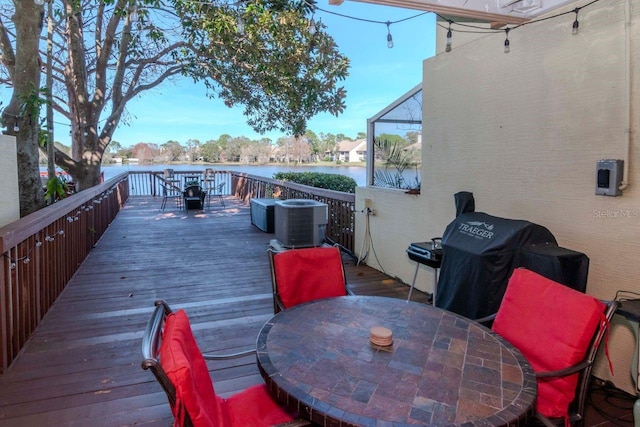 wooden terrace with a water view, area for grilling, and cooling unit