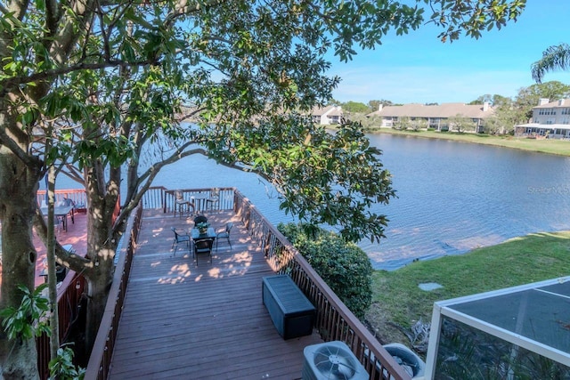 view of dock featuring a deck with water view and central AC unit