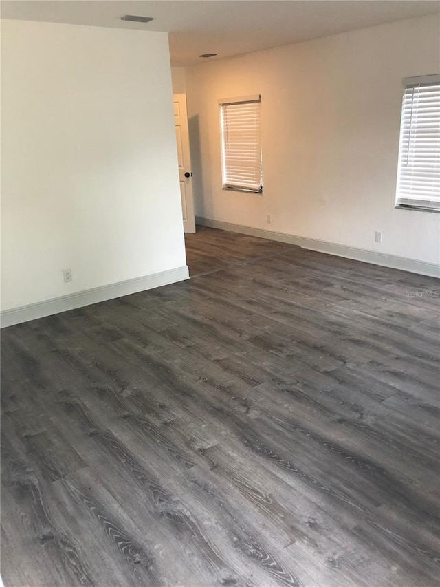 empty room with dark hardwood / wood-style floors