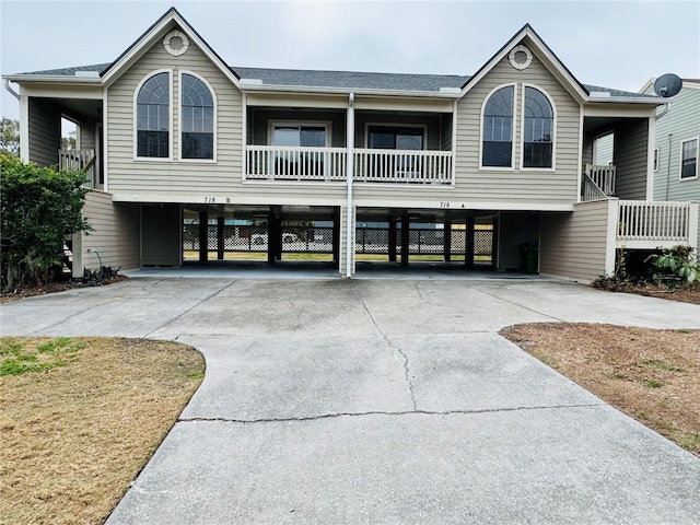 view of front of property with a carport and a balcony