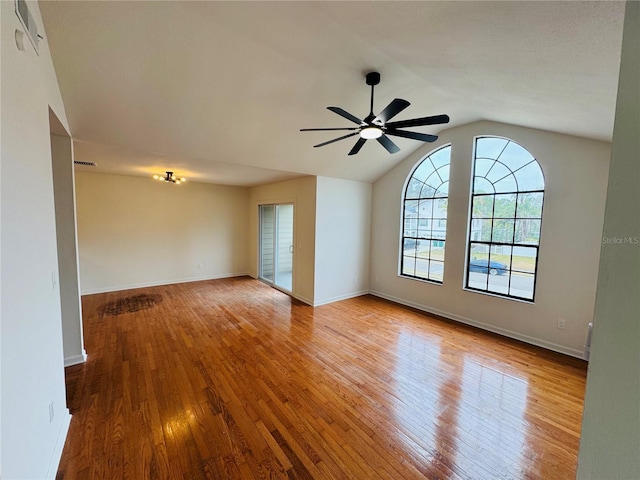 empty room featuring lofted ceiling, ceiling fan, and light wood-type flooring