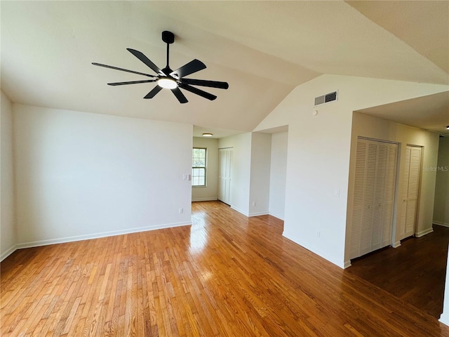 spare room with lofted ceiling, light hardwood / wood-style floors, and ceiling fan