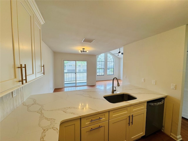 kitchen with sink, black dishwasher, kitchen peninsula, ceiling fan, and light stone countertops