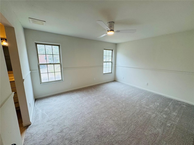 empty room with light carpet and ceiling fan