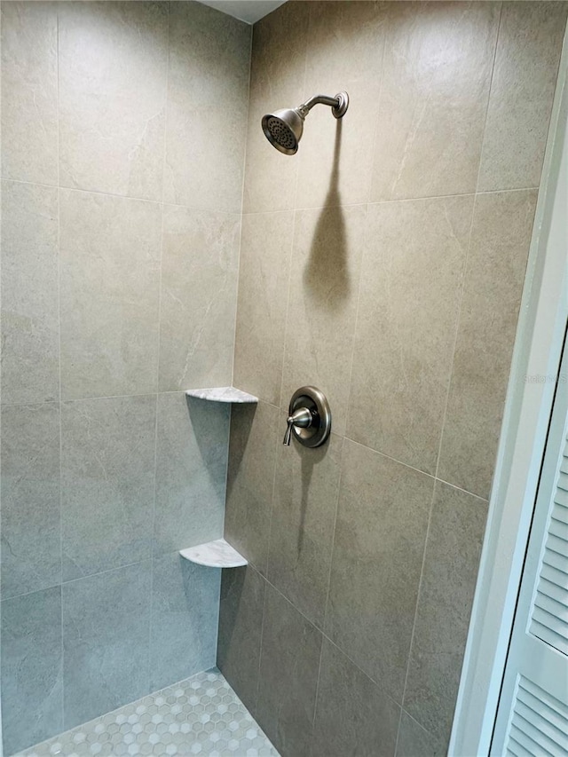 bathroom with a tile shower