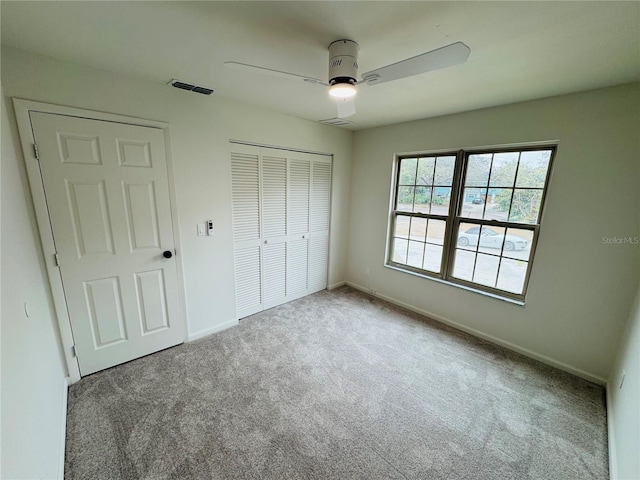 unfurnished bedroom featuring ceiling fan, carpet floors, and a closet