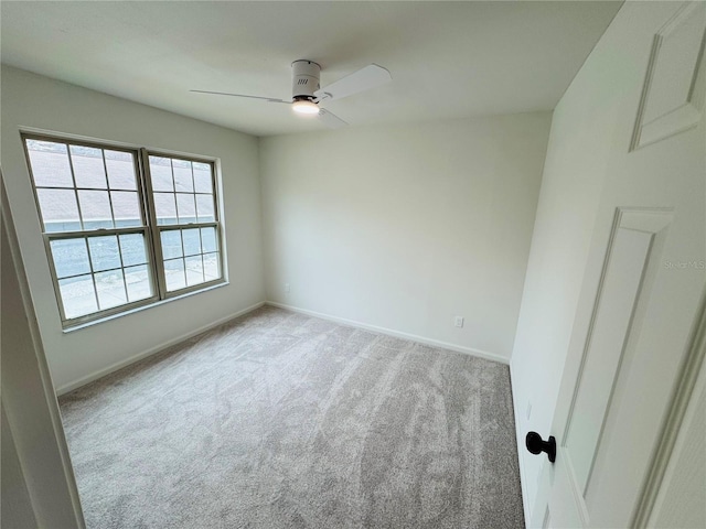 empty room with light carpet and ceiling fan