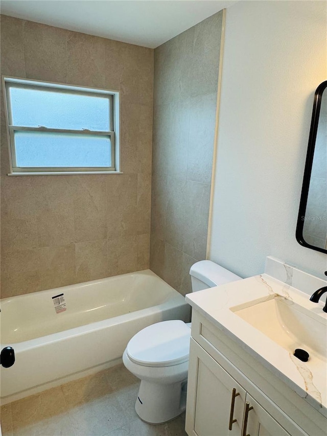 full bathroom with tiled shower / bath, vanity, toilet, and tile patterned floors