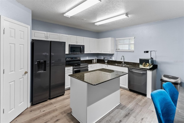 kitchen with sink, electric range oven, white cabinets, black fridge with ice dispenser, and stainless steel dishwasher