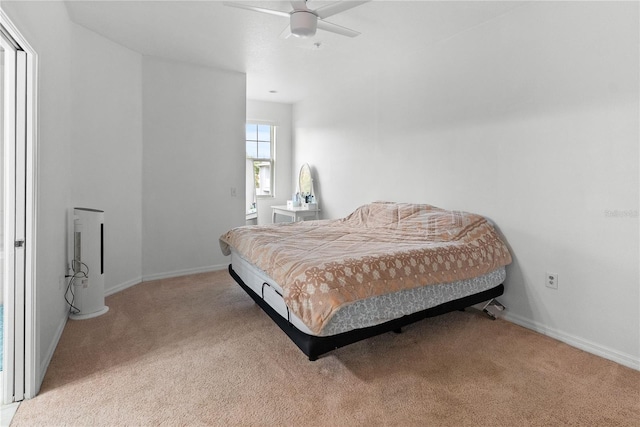 bedroom featuring ceiling fan and light carpet