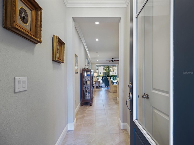 corridor with ornamental molding and light tile patterned floors