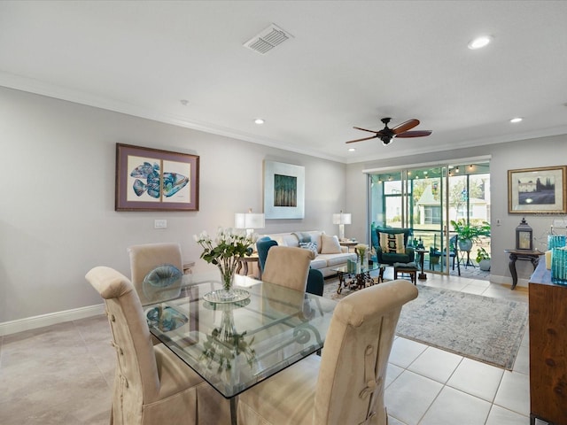 tiled dining room with crown molding and ceiling fan