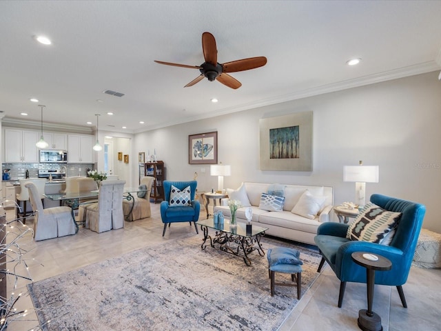 living room with light tile patterned floors, crown molding, and ceiling fan