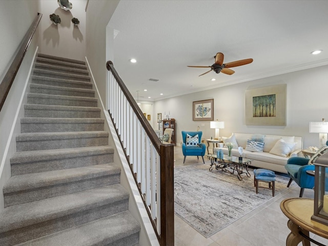 stairs featuring ornamental molding and ceiling fan