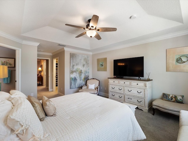 bedroom with a raised ceiling, ornamental molding, carpet, and ceiling fan